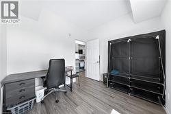 Room with wood-finish flooring and neutral wall tones - 