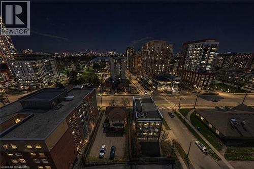 Urban skyline featuring diverse architectural styles, visible roadways, street lighting, and a distant green space - 246 Lester Street Unit# Ph-03, Waterloo, ON - Outdoor With View