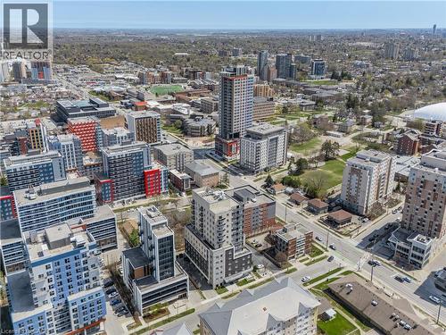 Urban landscape featuring a variety of multi-story buildings, extensive green spaces, and visible infrastructure elements - 246 Lester Street Unit# Ph-03, Waterloo, ON - Outdoor With View