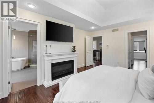 1335 Maple, Lasalle, ON - Indoor Photo Showing Bedroom With Fireplace