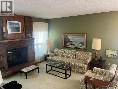 2930 More Crescent E, Regina, SK - Indoor Photo Showing Living Room With Fireplace