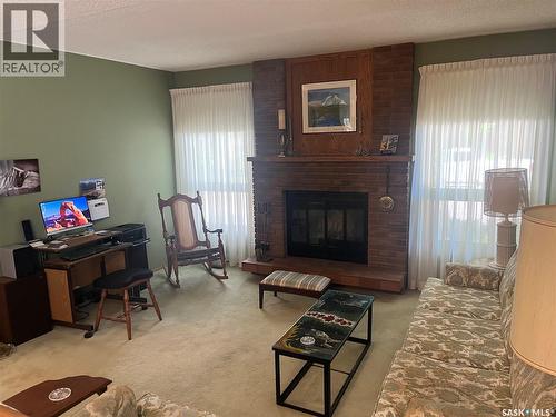2930 More Crescent E, Regina, SK - Indoor Photo Showing Living Room With Fireplace