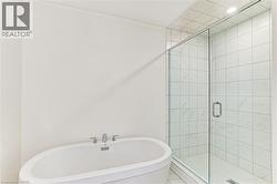 Freestanding soaking tub with chrome fixtures - 
