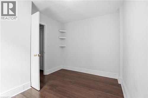 Room featuring wood-finish flooring, white walls, and white trim - 137 Market Street, Hamilton, ON - Indoor Photo Showing Other Room