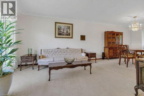 Spacious living area featuring light-toned carpeting and crown molding - 2344 Brinell Avenue, Burlington, ON - Indoor Photo Showing Living Room
