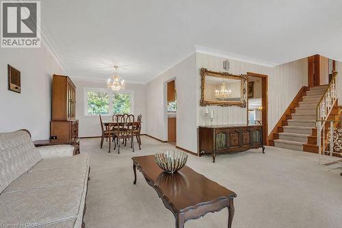 Open-concept living and dining areas featuring crown molding and carpeted flooring - 2344 Brinell Avenue, Burlington, ON - Indoor Photo Showing Other Room