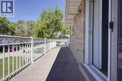 Exterior balcony featuring decorative white railings and a multi-tone stone facade - 