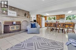 Expansive stone fireplace with a wood-burning insert and a tiled hearth - 