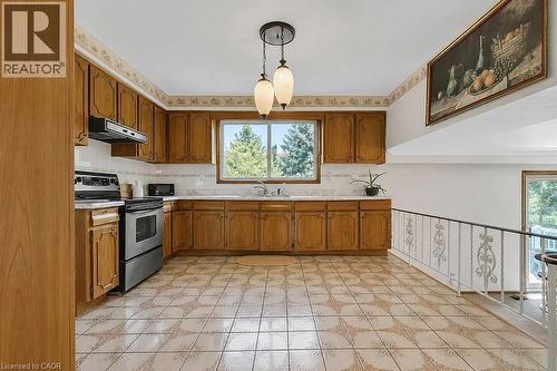 Kitchen featuring wood cabinetry, white tile countertops, and a full suite of stainless-steel appliances - 2344 Brinell Avenue, Burlington, ON - Indoor Photo Showing Kitchen