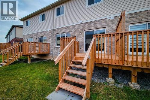 Rear exterior featuring a wood deck with stairs, brick and siding facade, and multiple windows - 111 Alicia Crescent, Thorold, ON 