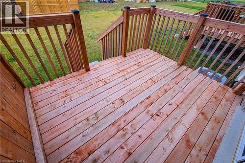 Expansive wood deck with a natural finish, featuring sturdy wood railings and steps descending to a grassed area - 111 Alicia Crescent, Thorold, ON 