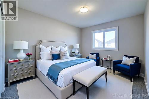 Bedroom featuring a window with white trim, a recessed light fixture, and wood-finish flooring - 111 Alicia Crescent, Thorold, ON 