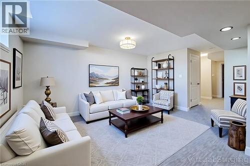 Spacious living area featuring neutral-toned walls, recessed lighting, and a drum-style ceiling fixture - 111 Alicia Crescent, Thorold, ON 