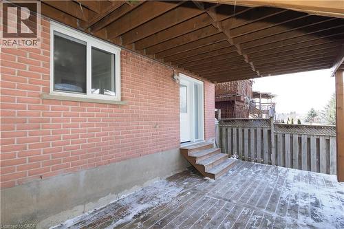 Expansive wooden deck featuring multiple steps, a lattice-top fence, and an overhead wooden structure - 67 Hollyridge Crescent Unit# Lower, Kitchener, ON - Outdoor With Deck Patio Veranda With Exterior