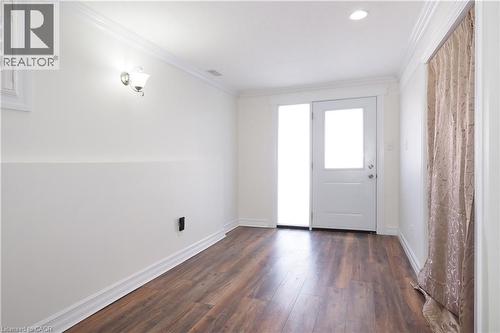 Room featuring wood-finish flooring, white baseboards, and crown molding - 67 Hollyridge Crescent Unit# Lower, Kitchener, ON - Indoor Photo Showing Other Room
