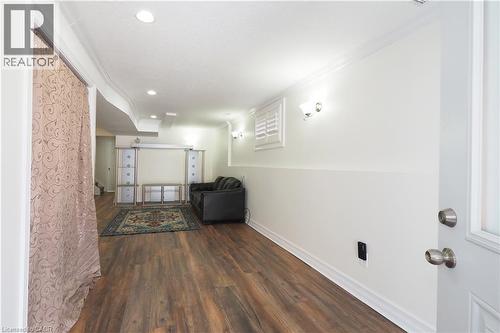 Finished basement area featuring wood-finish flooring, recessed lighting, and wall sconces - 67 Hollyridge Crescent Unit# Lower, Kitchener, ON - Indoor Photo Showing Other Room