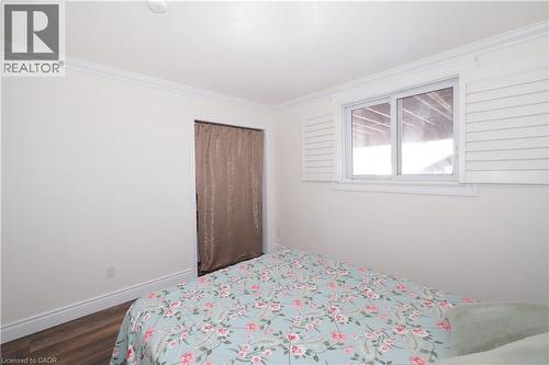 Interior room featuring wood-finish flooring, white baseboards, and crown molding - 67 Hollyridge Crescent Unit# Lower, Kitchener, ON - Indoor Photo Showing Bedroom