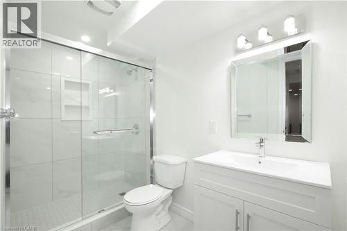 Bathroom featuring a glass-enclosed shower with tile surround, a built-in shower niche, and a white vanity with integrated sink - 67 Hollyridge Crescent Unit# Lower, Kitchener, ON - Indoor Photo Showing Bathroom