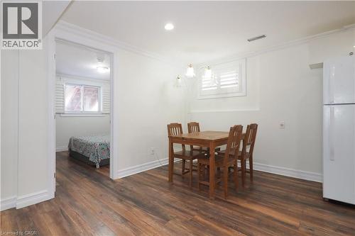 Wood-finish flooring throughout, complemented by white trim and crown molding - 67 Hollyridge Crescent Unit# Lower, Kitchener, ON - Indoor Photo Showing Dining Room