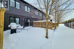 Rear exterior featuring dark brick and horizontal siding - 