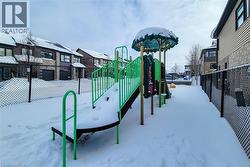 Outdoor play structure featuring a slide, climbing elements, and a decorative canopy - 