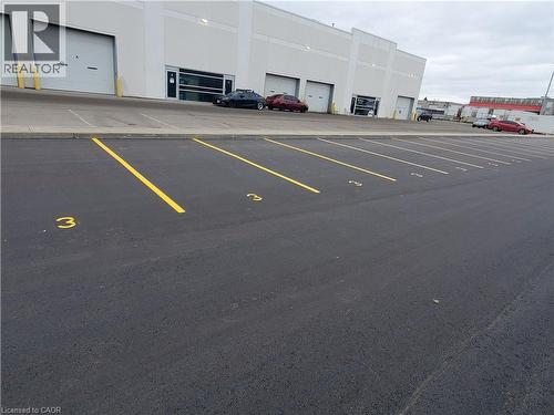 Paved asphalt parking area with clearly delineated yellow parking lines and numerical space markers - 44 Ditton Drive Unit# 3, Hamilton, ON 