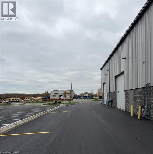 Industrial building featuring corrugated metal siding and a stone block base - 44 Ditton Drive Unit# 3, Hamilton, ON 