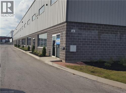 Commercial property featuring a dark brick facade and corrugated metal siding - 44 Ditton Drive Unit# 3, Hamilton, ON 