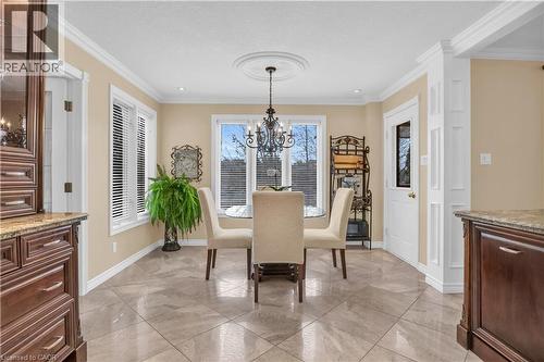 Dining area featuring large windows, crown molding, and diagonal tile flooring - 228 Michener Crescent, Kitchener, ON - Indoor Photo Showing Dining Room