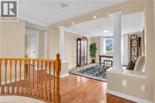 Open concept layout featuring hardwood flooring, decorative columns, recessed lighting, and crown molding - 228 Michener Crescent, Kitchener, ON - Indoor Photo Showing Other Room