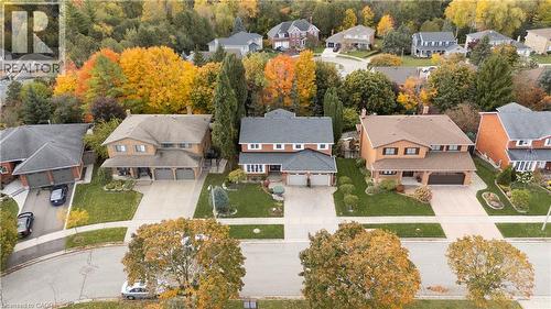 Brick-clad home featuring a two-car garage, dormer windows, and a covered front entry - 228 Michener Crescent, Kitchener, ON - Outdoor With View