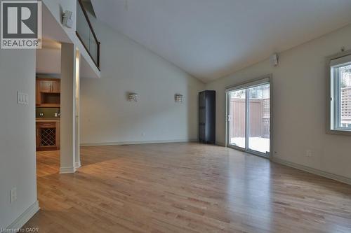 Spacious room featuring wood-finish flooring and a vaulted ceiling - 7 Gibson Place Unit# 21, St. Catharines, ON - Indoor Photo Showing Other Room