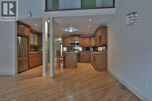 Kitchen featuring light wood cabinetry, stainless steel appliances, and a central island - 7 Gibson Place Unit# 21, St. Catharines, ON - Indoor Photo Showing Kitchen