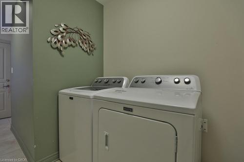 Dedicated laundry area featuring a white top-load washing machine and a white front-load dryer - 7 Gibson Place Unit# 21, St. Catharines, ON - Indoor Photo Showing Laundry Room