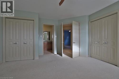 Spacious room featuring light blue walls and plush carpet flooring - 7 Gibson Place Unit# 21, St. Catharines, ON - Indoor