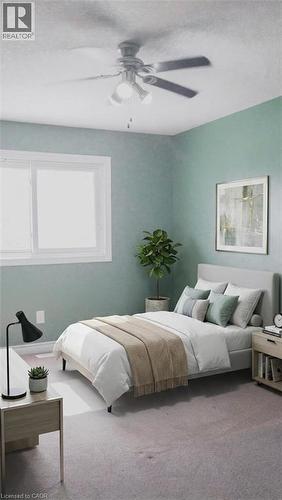 Bedroom featuring a flush-mount ceiling fan with integrated lighting, a large window with white trim, and light-colored carpeting. Virtually staged. - 569 Activa Avenue, Kitchener, ON - Indoor Photo Showing Bedroom