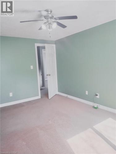 Interior room featuring light green walls, a white ceiling, and light-colored carpeting - 569 Activa Avenue, Kitchener, ON - Indoor