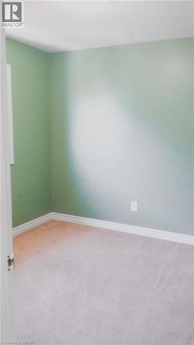 Interior room with light green walls and neutral-toned carpeting - 569 Activa Avenue, Kitchener, ON - Indoor Photo Showing Other Room