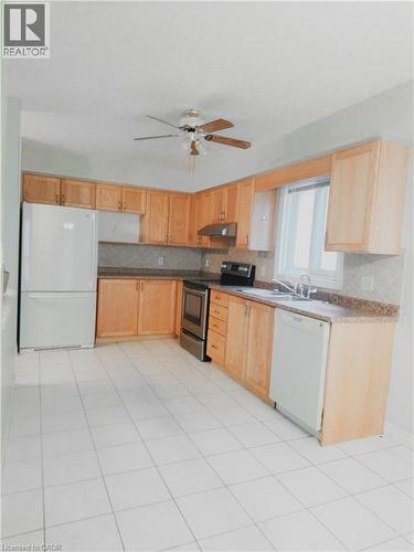 Kitchen featuring light wood cabinetry and light-toned countertops - 569 Activa Avenue, Kitchener, ON - Indoor Photo Showing Kitchen