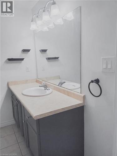 Bathroom vanity with a light-toned countertop and integrated sink basin - 569 Activa Avenue, Kitchener, ON - Indoor Photo Showing Bathroom