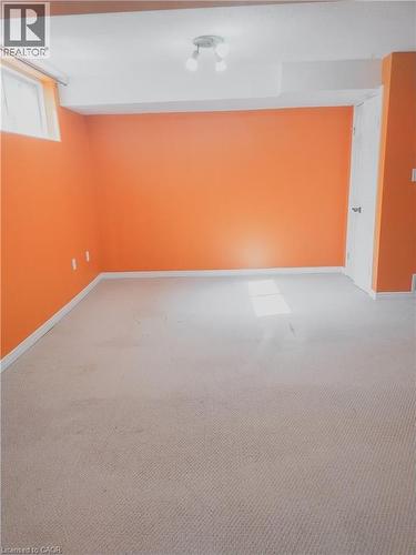 Carpeted room with orange walls and white trim - 569 Activa Avenue, Kitchener, ON - Indoor Photo Showing Other Room