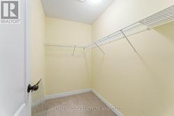 1 of 2 walk in closets in primary bedroom - 