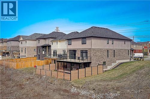 Rear view of house featuring a residential view, fence, and brick siding - 477 Blair Creek Drive, Kitchener, ON - Outdoor