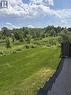 Expansive green space featuring a sloped lawn and natural landscaping - 477 Blair Creek Drive, Kitchener, ON 