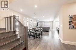 Dining area with recessed lighting, stairway, baseboards, and wood finished floors - 