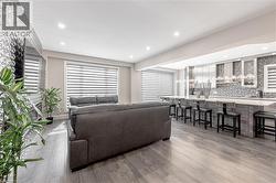 Living room with recessed lighting, plenty of natural light, and wood finished floors - 