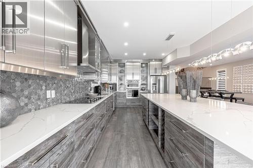 Kitchen featuring wall chimney exhaust hood, modern cabinets, gray cabinets, stainless steel fridge, and black electric stovetop - 477 Blair Creek Drive, Kitchener, ON - Indoor Photo Showing Kitchen With Upgraded Kitchen