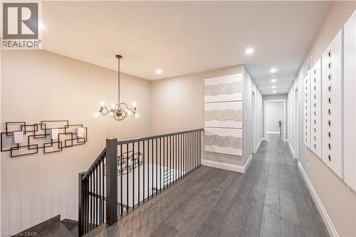 Hallway featuring wood-style flooring, an inviting chandelier, baseboards, and recessed lighting - 477 Blair Creek Drive, Kitchener, ON - Indoor Photo Showing Other Room