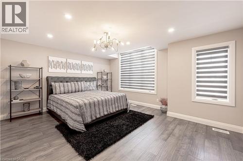 Bedroom with baseboards, a chandelier, and wood finished floors - 477 Blair Creek Drive, Kitchener, ON - Indoor Photo Showing Bedroom