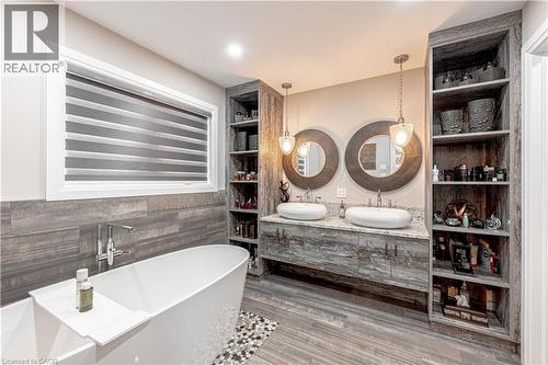 Full bath featuring a freestanding bath, double vanity, a sink, and ceramic tile finished floors - 477 Blair Creek Drive, Kitchener, ON - Indoor Photo Showing Bathroom